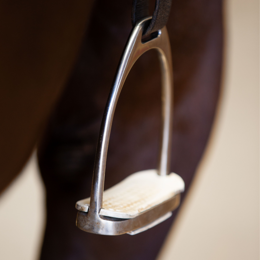 Stirrup hanging from the saddle.